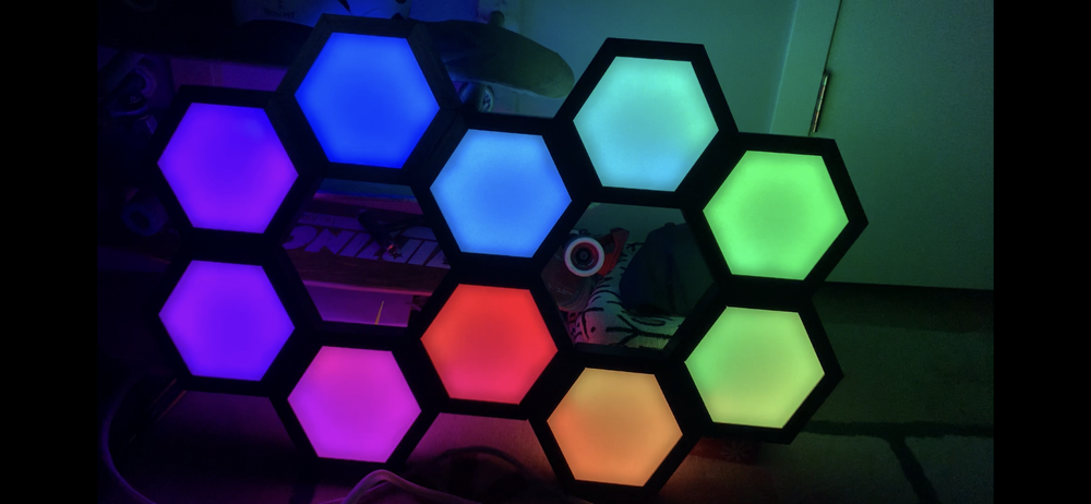 Dynamic rainbow gradient running across the hexagonal array