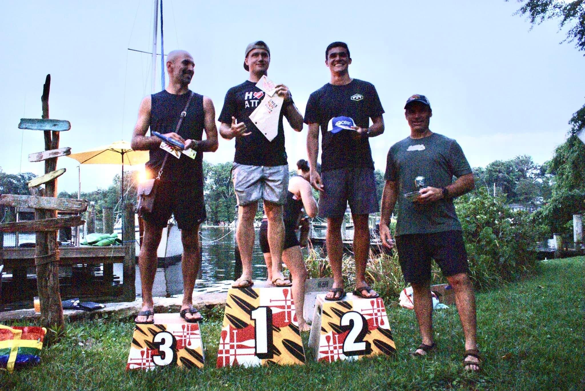 Podium presentation with winners receiving wooden awards