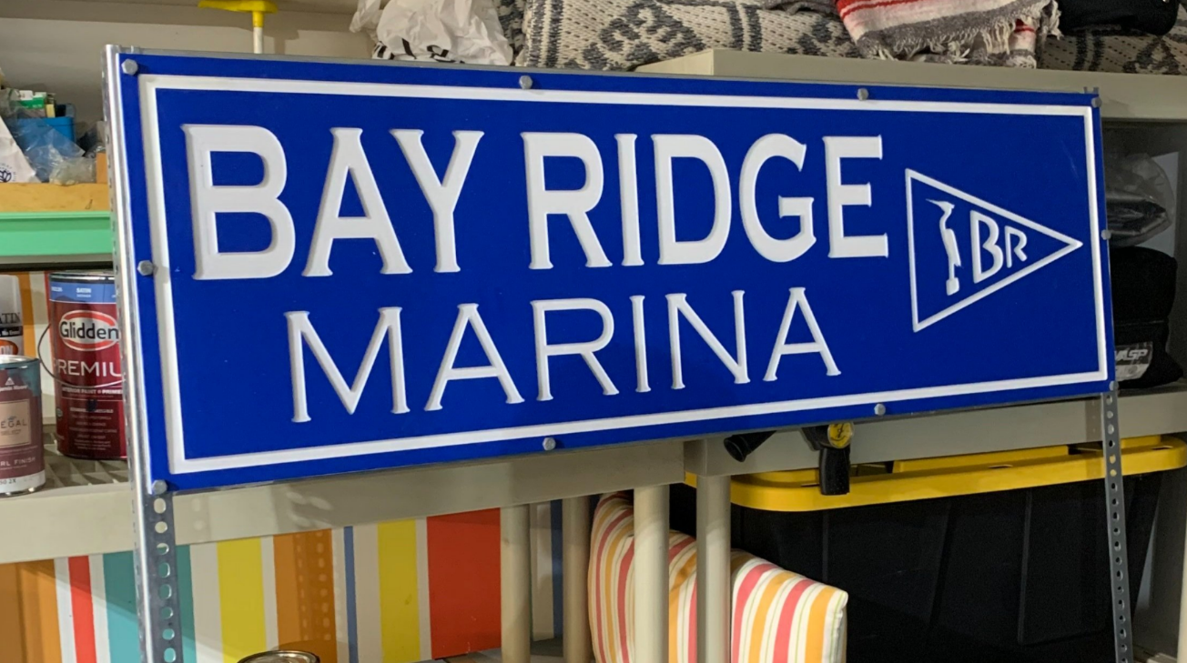 CNC-machined marine wayfinding sign installed at neighborhood marina